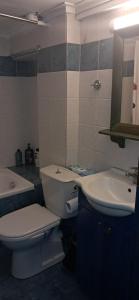 a bathroom with a white toilet and a sink at ABC Studios B in Lamía +11 photos