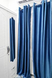 a group of blue curtains in a room at Cj apartment kasoa in Kasoa