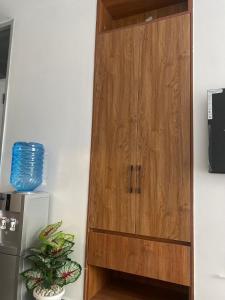 a wooden cabinet in the corner of a room at CozMila homes in Kiambu