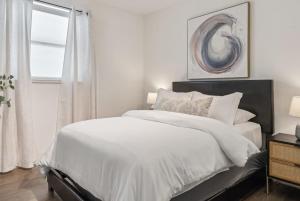 a bedroom with a white bed and a window at Penthouse Luxe Views No 604 in Dallas +27 photos