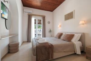 a bedroom with a bed and a tv in a room at Katsaros Studios & Apartments in Sidari +30 photos