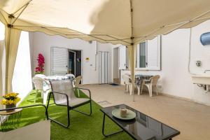 a patio with a table and chairs and a tent at Le Camere Di Anna in Gallipoli