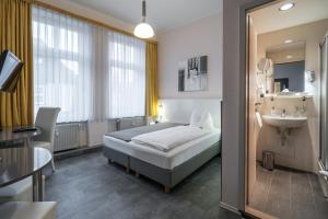 Postel nebo postele na pokoji v ubytování Hotel Stadtkrug