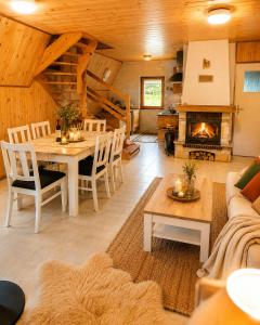 a living room with a table and a fireplace at Domki Bieszczady Siedlisko Harenda in Czarna