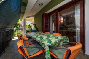 a table and chairs on a porch with a table at Moonvidal residence with big private swimming pool and free parking in Pula