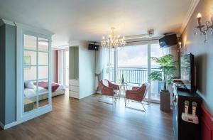 a living room with a table and chairs and a bedroom at Yeongduk Brie Pension in Yŏngdŏk
