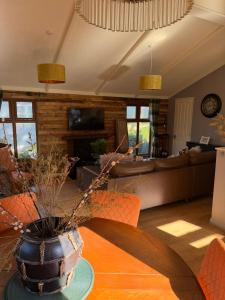 a living room with a table and a couch at Woodside Lodge, Weybourne, Holt in Weybourne