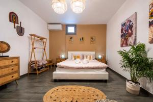 a bedroom with a large bed and a table at Villa Cycladic View Syros in Azolimnos Syros +77 photos