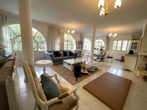 a living room with a couch and a table at Villa Jasmin in Hammamet