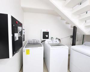 two washing machines in a white room with a staircase at Hotel Posada Centro Atlacomulco Cuarto Barra in Atlacomulco de Fabela