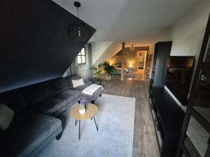 a living room with a couch and a table at FeWo im Forsthaus in Marktredwitz