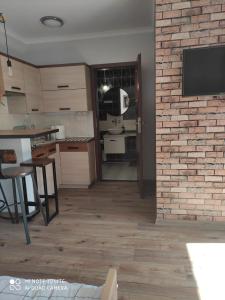 a kitchen and dining room with a brick wall at Pokoje Gościnne Leśna 33 in Sława