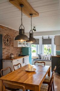 a kitchen with a wooden table and a dining room at apartament BB in Podgórzyn