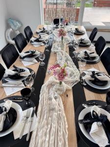 a long table with glasses and plates on it at Domki u Duszy Wielka Dusza in Brenna