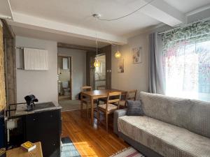 a living room with a couch and a table at Chatka w Narwi in Narew