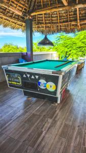 a pool table sitting inside of a room with at 7G Residency Bwejuu in Bwejuu
