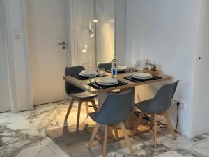 a dining room table with four chairs in a room at Lichtdurchflutete Suite mit Lichthof in Karlsruhe +4 photos