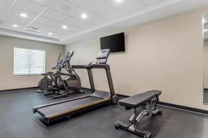 a gym with cardio machines and a flat screen tv at Sleep Inn & Suites Liberty in Liberty