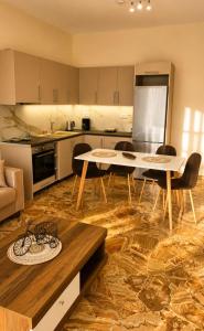 a kitchen with a table and chairs in a room at MariosGuestHouse in Ancient Epidauros