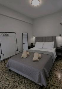 a bedroom with a large bed with two towels on it at MariosGuestHouse in Ancient Epidauros