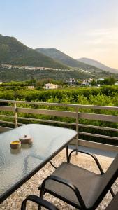 a table and chairs on a balcony with a view at MariosGuestHouse in Ancient Epidauros