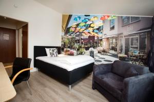 a bedroom with a bed and a couch in a store at Hotel Hedegaarden in Vejle