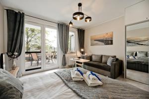 a living room with a bed and a couch at BlueApart Apartamenty Nexo in Puck