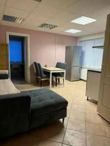 a conference room with a table and chairs and a couch at Paide Apartment in Paide