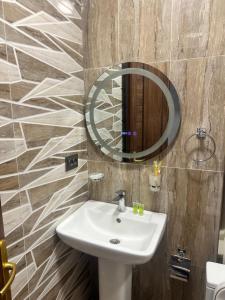 a bathroom with a sink and a mirror at Gasparyan's Guest House in Pʼarakʼar