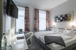Postel nebo postele na pokoji v ubytování Hotel Stadtkrug