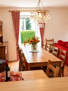a dining room with a table with a vase of flowers at Ferienhaus Jenig in Jenig