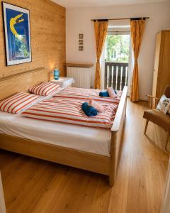 a bedroom with a large bed with two pillows at Ferienhaus Jenig in Jenig +6 photos