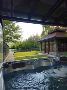 a hot tub in a backyard with a gazebo at Villa ENT in Bihać