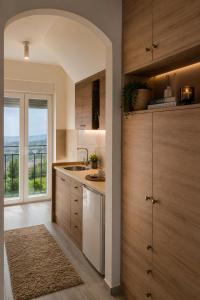 a kitchen with wooden cabinets and a view of the ocean at Blue Skies in Podgorica