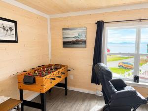 a room with a table with a game of chess at Long Beach Lookout Vacation Rental in Twillingate +1 photo