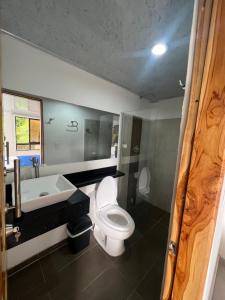 a bathroom with a toilet and a sink and a tub at Eco hotel el molino in San Luis