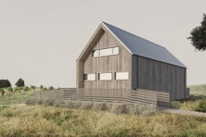 a wooden barn with a black roof on a field at Sandvikens Strandby in Katthammarsvik