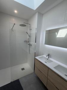 a white bathroom with a shower and a sink at Le Panier in Alixan