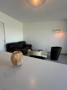 a living room with a couch and a table at Le Panier in Alixan