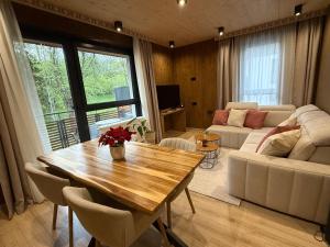 a living room with a table and a couch at Apartmán Forest, Tatranská Štrba in Tatranska Strba