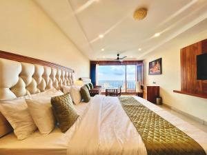 a bedroom with a large bed with a large window at Mokshada Hotel & Resort A Premium Property Near Jaypee in Mussoorie +77 photos