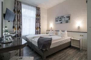 Postel nebo postele na pokoji v ubytování Hotel Stadtkrug