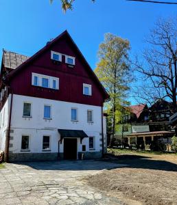 a large white building with a red roof at DW Bukówka in Karpacz