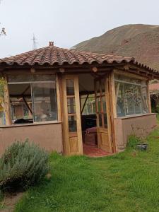 a small house with a tiled roof at Mrs Sapo Chalets in Urubamba