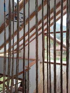 a room with wooden ceilings and a window at Mrs Sapo Chalets in Urubamba +28 photos