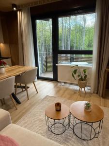 a living room with a couch and a table at Apartmán Forest, Tatranská Štrba in Tatranska Strba