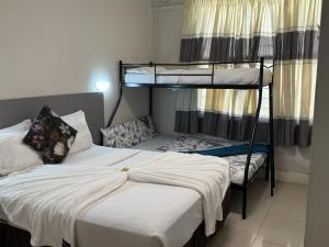 a bedroom with two bunk beds and a bed at JH Guest house in Durban