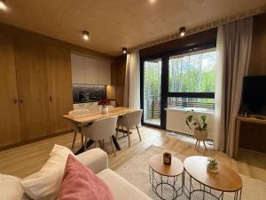 a living room with a couch and a table at Apartmán Forest, Tatranská Štrba in Tatranska Strba +17 photos