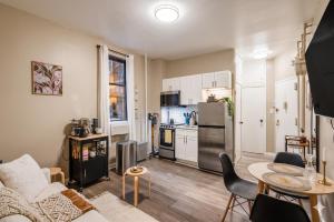 a living room with a couch and a table at The Ultimate NYC Base 1BR near Times Sq & Columbus Circle in New York