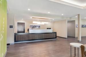 an office lobby with a reception desk and chairs at Sleep Inn & Suites Liberty in Liberty